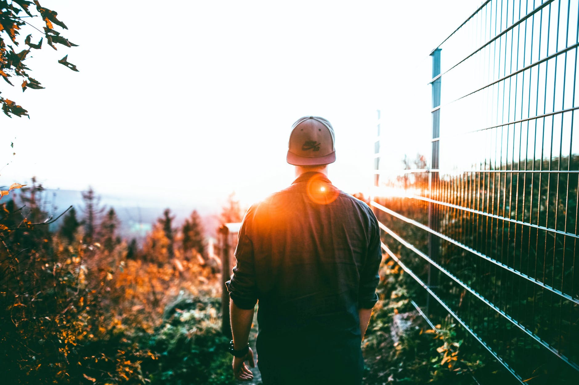 man walking toward sun.jpeg