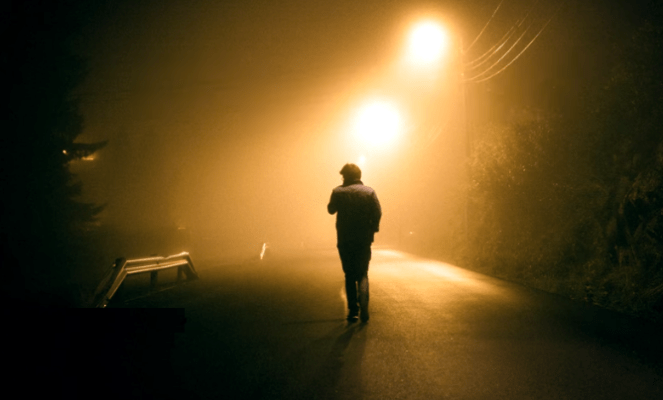 man walking night
