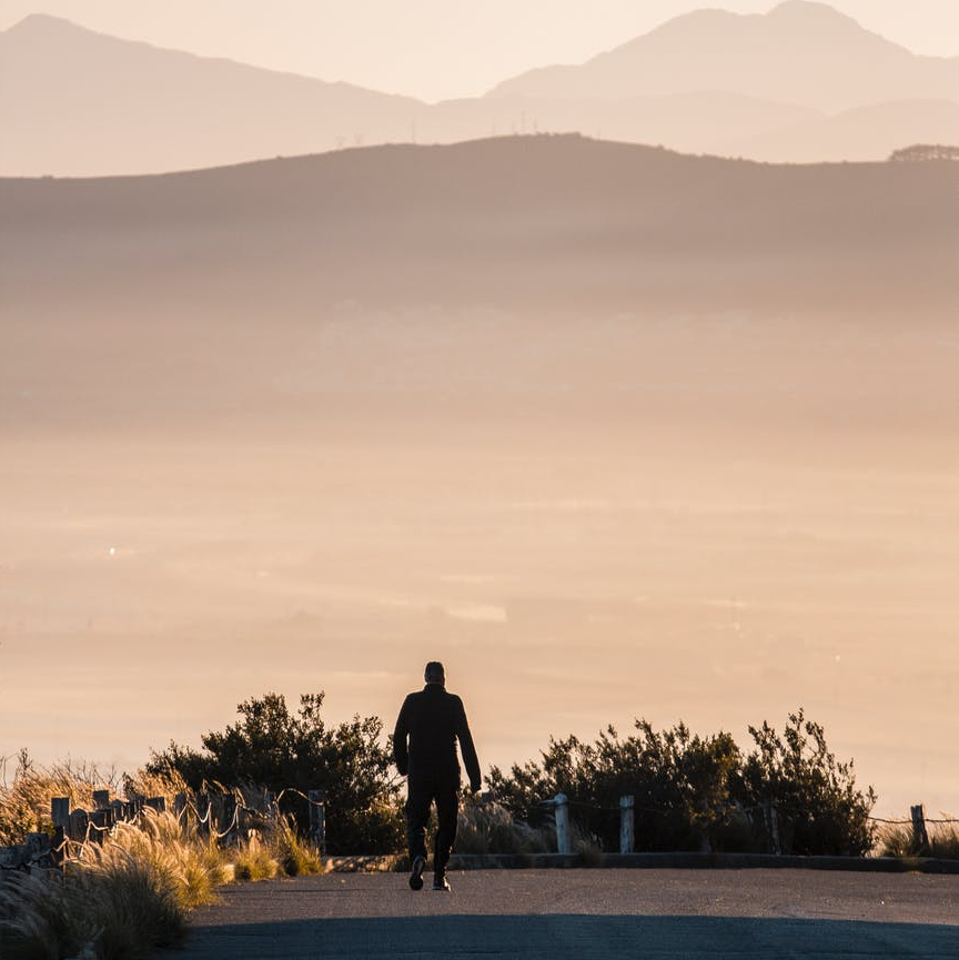 man walking road
